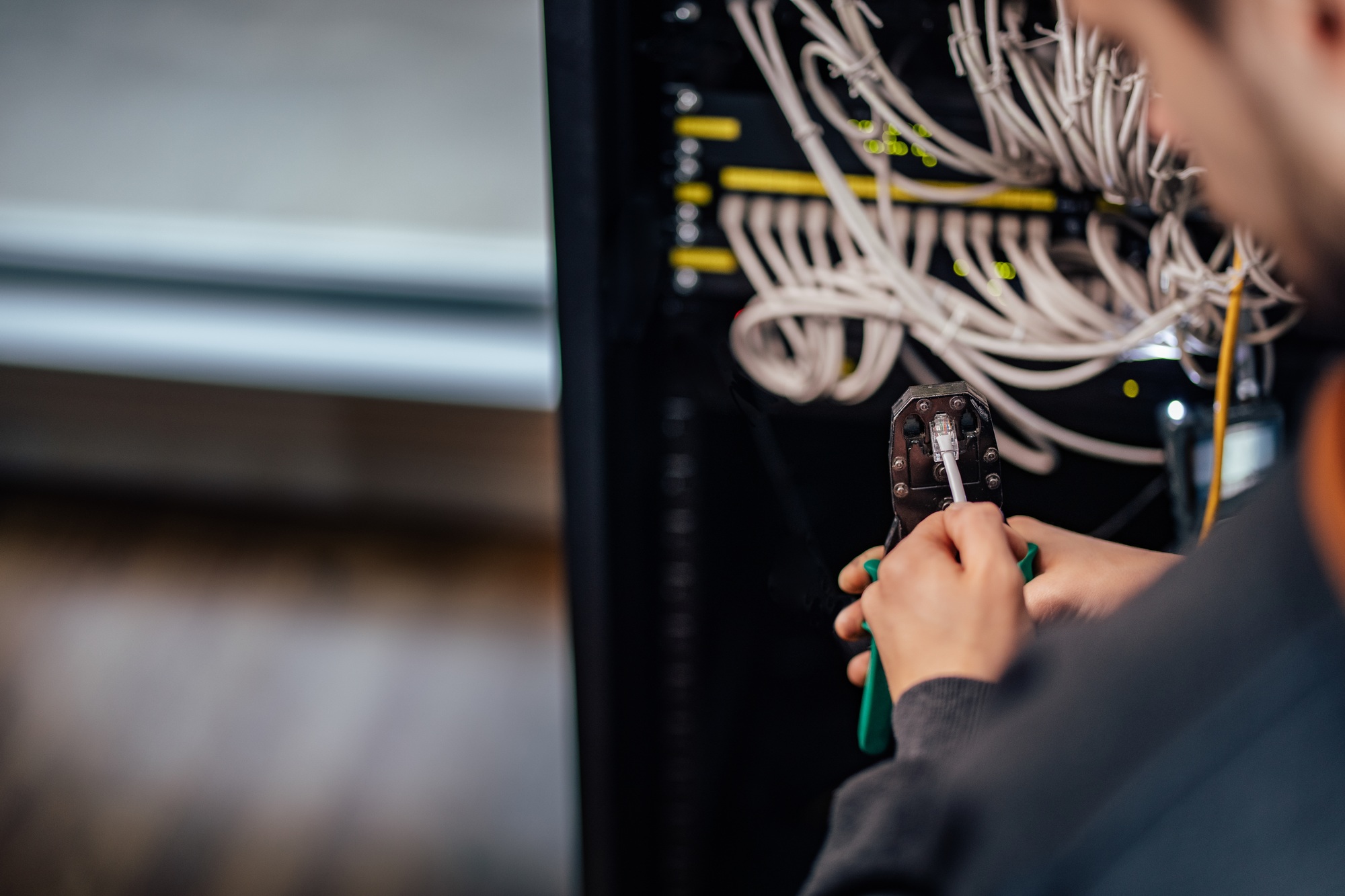 Setting up a network. Crimping connector with network tool kit, close-up.